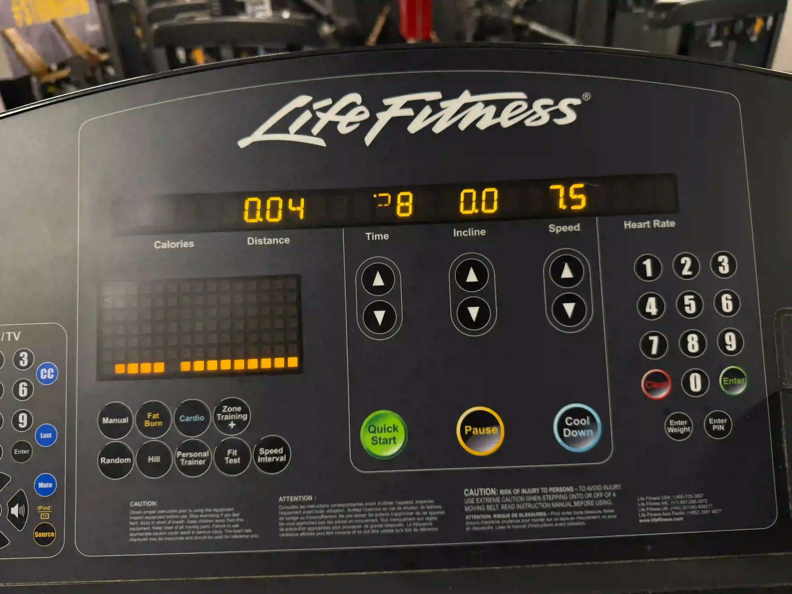Close-up of a Life Fitness treadmill console display showing metrics for distance, time, incline, and a speed setting of 7.5.