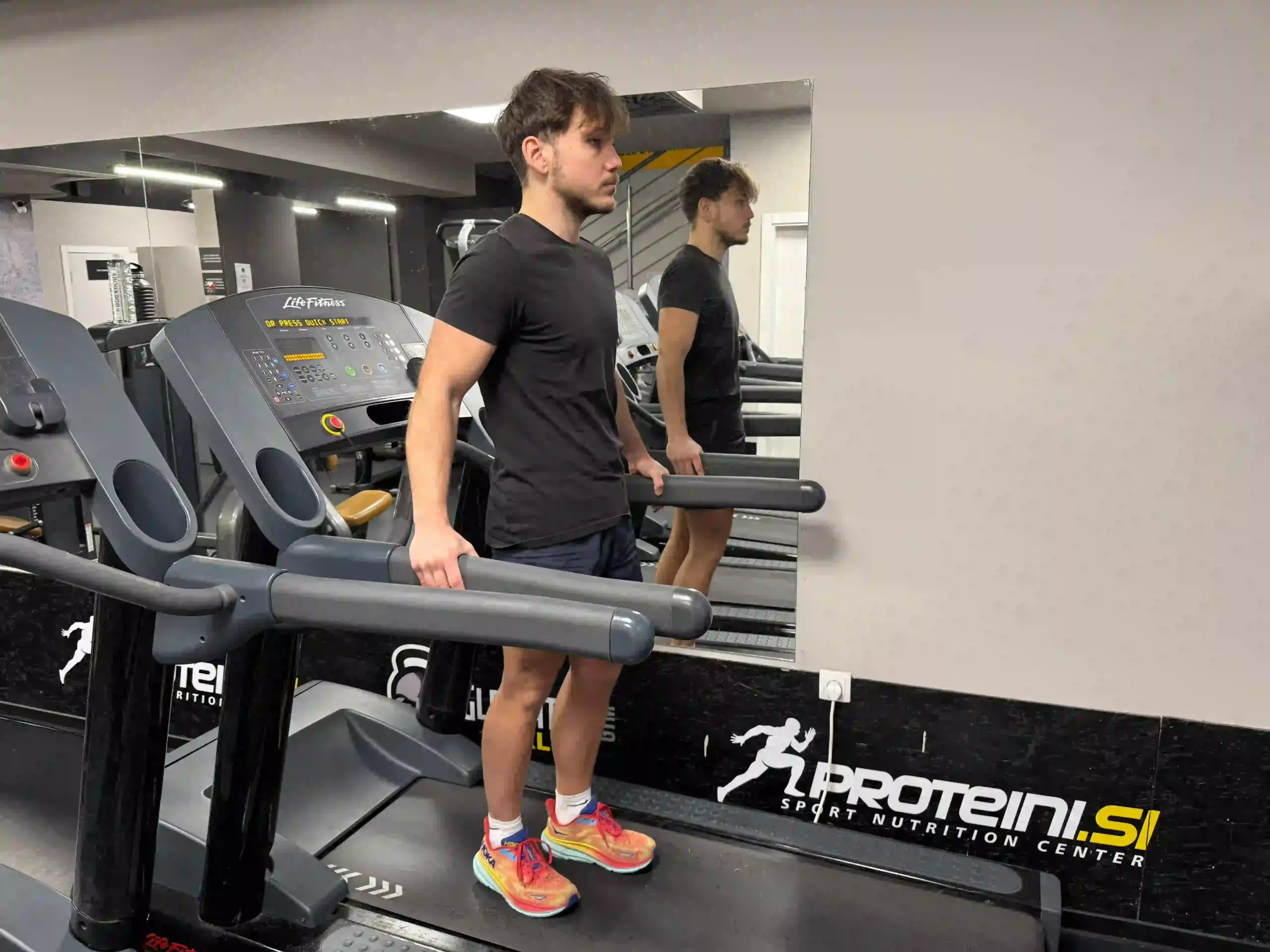 Milutin standing on the treadmill in a public gym