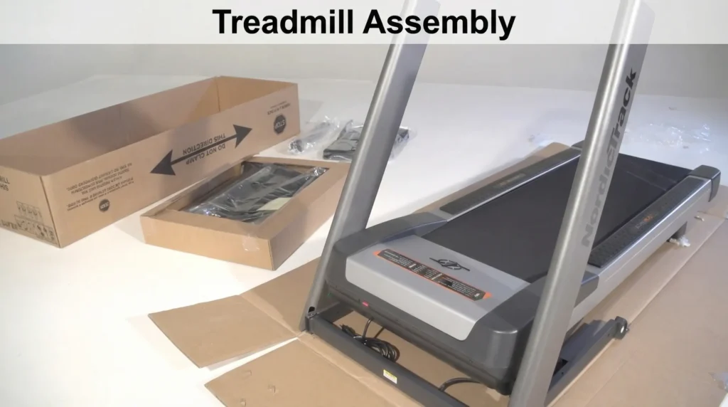 Treadmill Assembly header image showing partially assembled treadmill with upright posts in place, open cardboard packaging boxes with hardware and parts, in white room setting with text overlay 'Treadmill Assembly