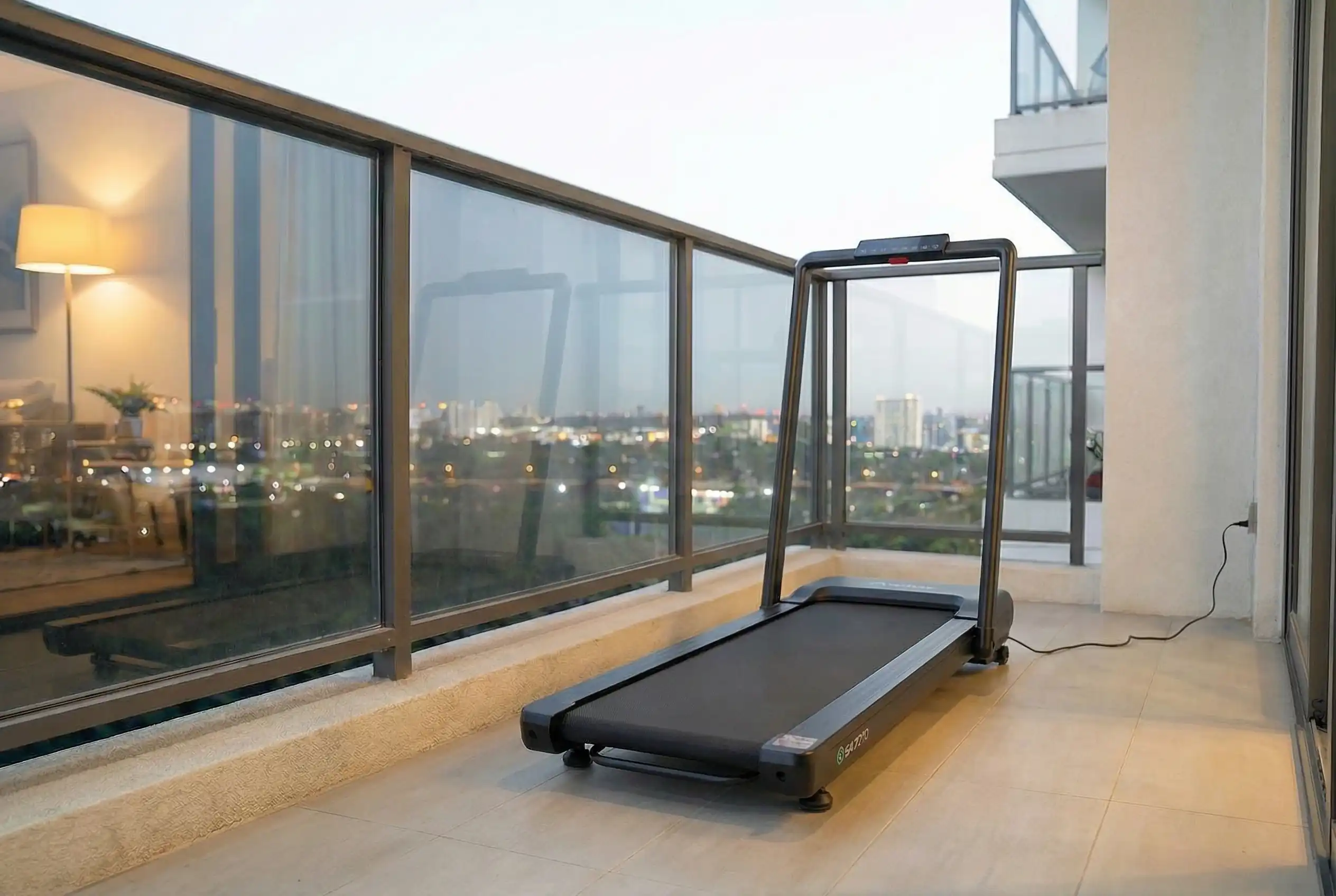 Urevo Smart Treadmill with Auto Incline on modern balcony terrace with floor-to-ceiling windows and panoramic city skyline view at dusk