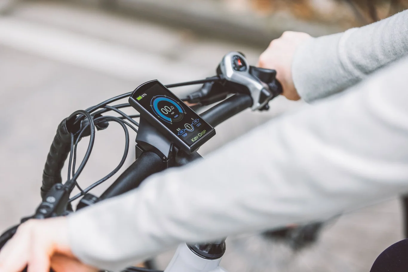 Close-up of a smart bike computer display mounted on handlebar showing speed and distance data