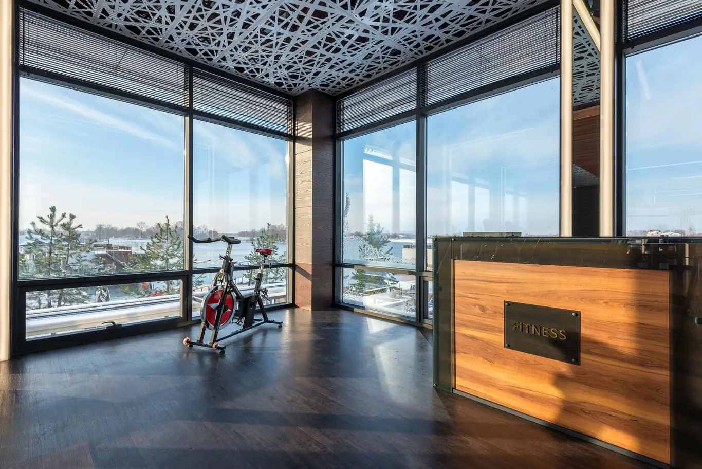 Stationary spin bike in a modern fitness room with floor-to-ceiling windows