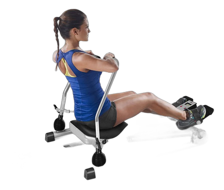 Woman rowing on a SPORFIT hydraulic machine with a padded seat and adjustable foot straps
