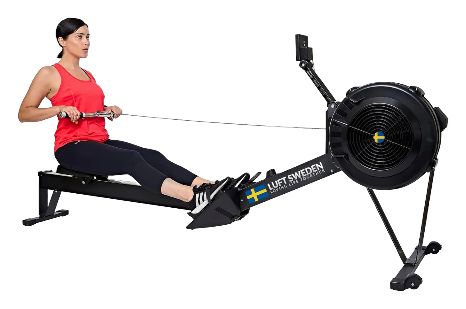 Woman using the LUFT Sweden rowing machine with a black frame and fan style flywheel