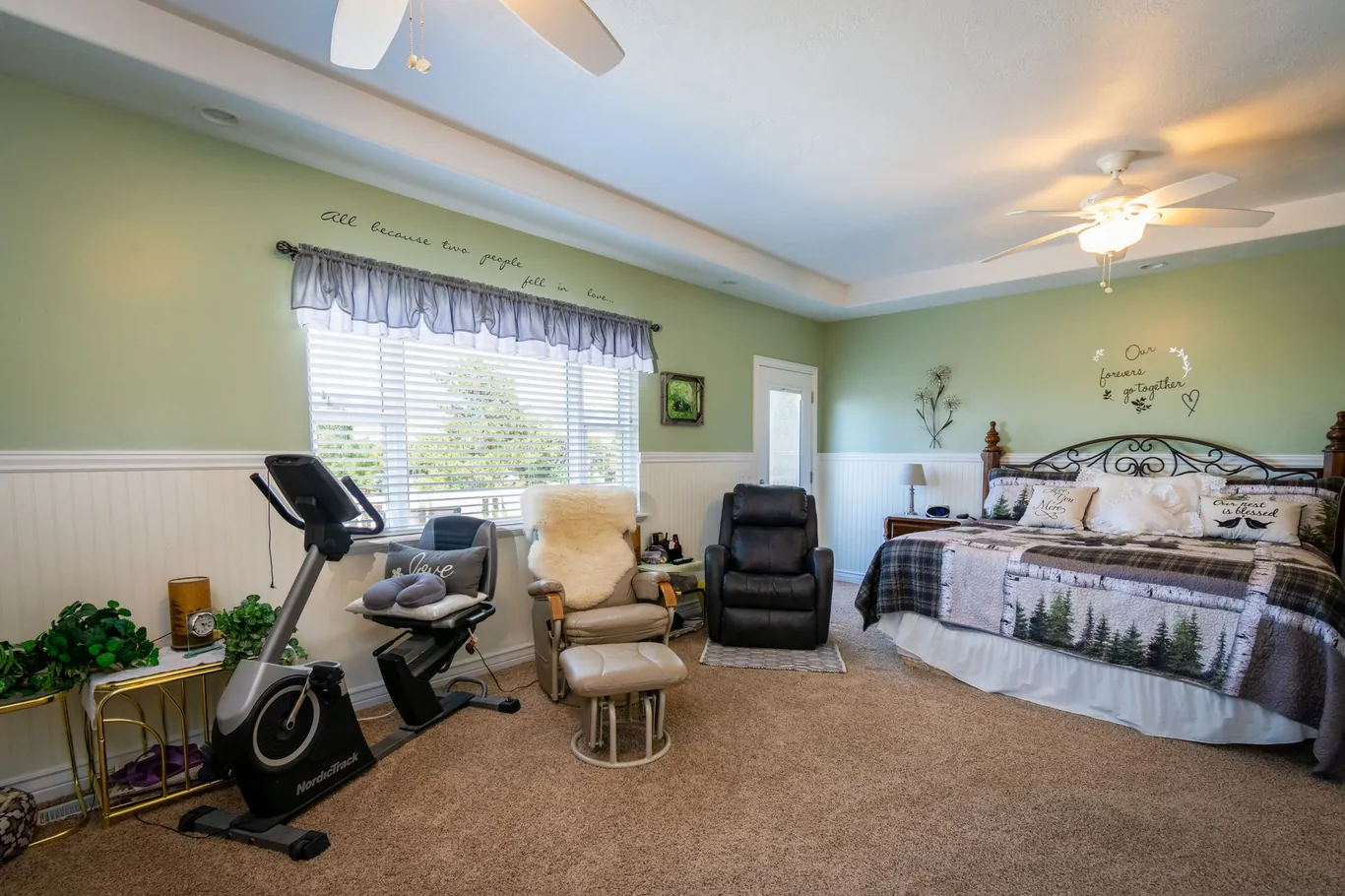 Upright exercise bike in a home bedroom gym setup near a bright window