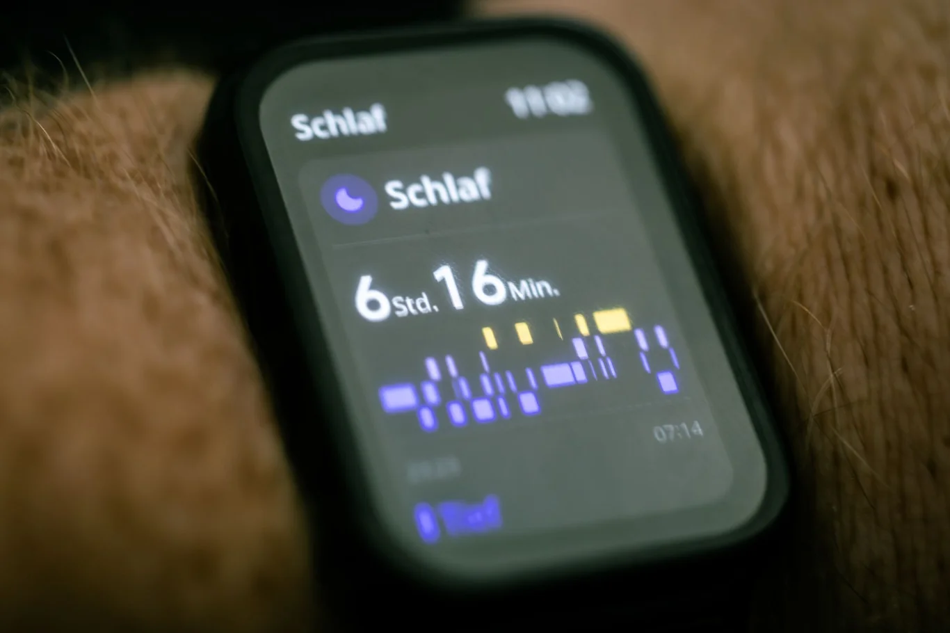 Smartwatch on a wrist displaying a nighttime sleep tracking summary