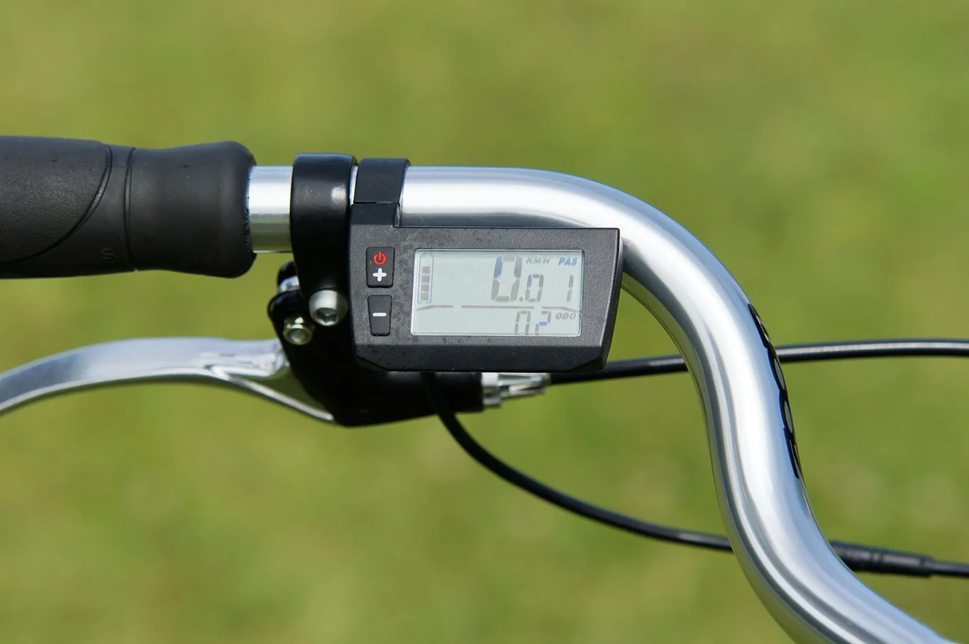Bicycle handlebar with a digital display console showing speed and distance readouts