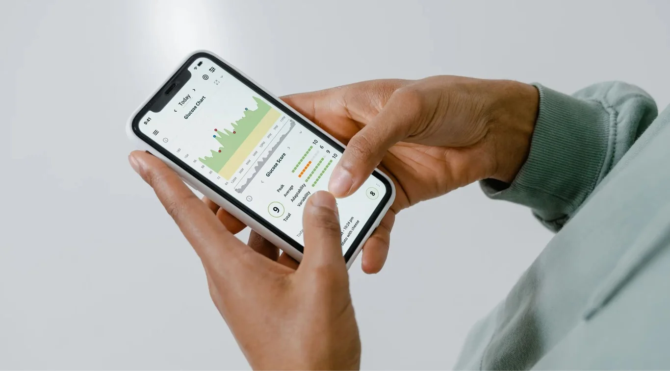 Hand holding a smartphone showing fitness app activity data on screen