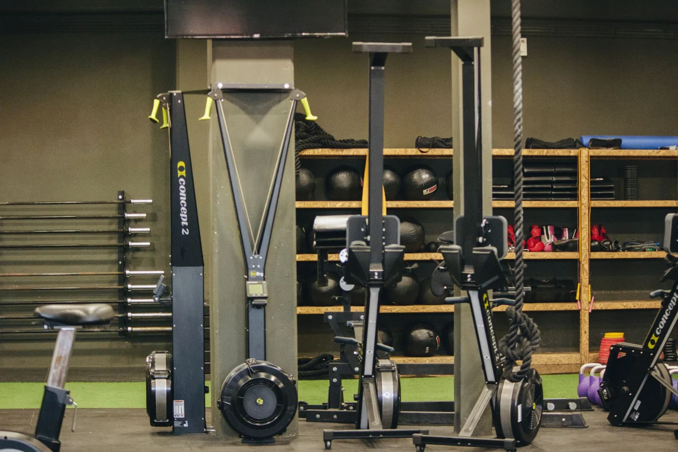 Concept2 rowing machines lined up beside other equipment in a gym