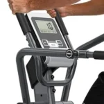 Close-up of the THERUN recumbent elliptical console display and handlebar grips