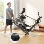 Man tilting and rolling the THERUN recumbent elliptical on its built-in transport wheels