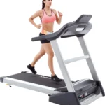 Woman running on Spirit XT385 treadmill, front angle