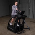 Man using the Body-Solid E5000 Endurance elliptical in a warehouse gym