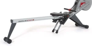 Sole rower folded with front transport wheels, rail badge reads SR500