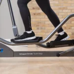Close-up of feet on the Life Fitness E1 pedals showing WhisperStride technology