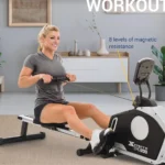 Woman rowing the XTERRA ERG200 in a living room with an 8-level magnetic resistance callout
