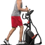 Woman using the Schwinn 411 compact elliptical, side view