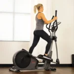 Woman using the Sunny SF-E3912 heavy duty elliptical, rear angle showing stride