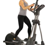 Woman using the Sunny SF-E3912 heavy duty elliptical, three-quarter view