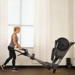 Sunny SF-E3912 elliptical tilted onto transport wheels for moving