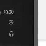 Close-up of the Echelon Reflect screen's rounded corner showing timer, heart rate, and audio icons