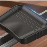 Close-up of the YOSUDA PRO rower padded seat on the aluminum rail