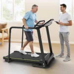 Senior man using Redliro treadmill with an assistant present for rehabilitation training