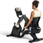 Person riding the Schwinn 290 recumbent bike, rear three-quarter view