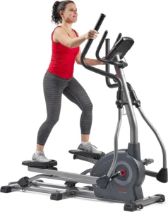Woman using the Sunny SF-E320048 long stride elliptical, three-quarter view
