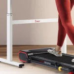 Close-up of feet on the Sunny Treadpad Slim showing its fit under a standing desk