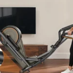 Woman wheeling the Niceday Hyper-Quiet elliptical on its built-in transport wheels