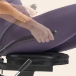 Sunny Health & Fitness Smart Recumbent Bike pivoting side handle, close-up of hand gripping the rehab-style handle