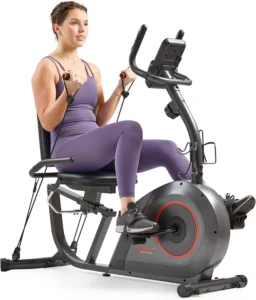 Woman using resistance bands while pedaling the Sunny Health & Fitness Smart Recumbent Bike with wide cushioned seat and console
