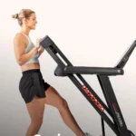 Person demonstrating folding the Sunny SF-T724082 treadmill for storage