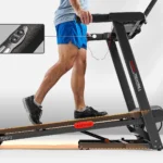 Person walking on Sunny SF-T724012 treadmill, side view showing incline quick-adjust buttons