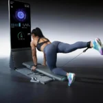 Woman doing a standing cable kickback exercise pulled from the mirror's low anchor point
