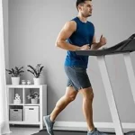 Adult man running on the WELLFIT Heavy Duty 15 percent auto incline foldable treadmill