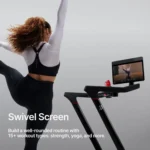 Woman doing an off-tread strength workout in front of the Peloton Tread's swiveled touchscreen
