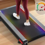 Close-up of the multicolor LED belt lighting and speed gauge on the Jogwell 12/20 extra-wide walking pad