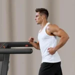 Renestar folding treadmill, side profile close-up of console and handrail while in use
