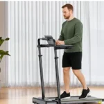 Man working at the standing desk attachment on the Acezoe 3-in-1 under-desk treadmill