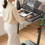 Close-up of the UREVO Foldimix adjustable desk with laptop, remote, and console display