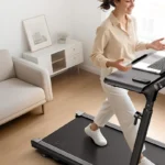 Person walking on the UREVO Foldimix at the adjustable desk, front angle