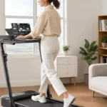 Person walking on the UREVO Foldimix at the adjustable desk, rear angle