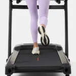 Close-up of feet on the BowFlex T16 FlexZone XL cushioned deck
