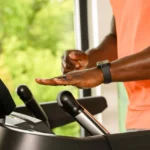 Close-up of hand adjusting the BowFlex T16 quick-dial incline control