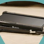 Side angle of the Lifepro PacerMini incline walking pad on a living room rug
