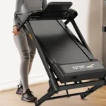 Woman pulling the folded JAGJOG 15 percent auto incline treadmill across the floor
