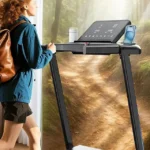 Woman running on the JAGJOG 15 percent auto incline treadmill against a composited forest trail backdrop
