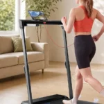 Rear view of the JAGJOG walking pad with height-adjustable handlebar and laptop tray in use